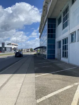 Exterior view of a commercial building with parking spaces. - image 11