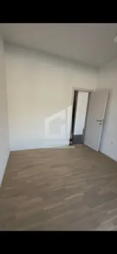 Prazna soba sa bijelim zidovima i drvenim podom. - image 8