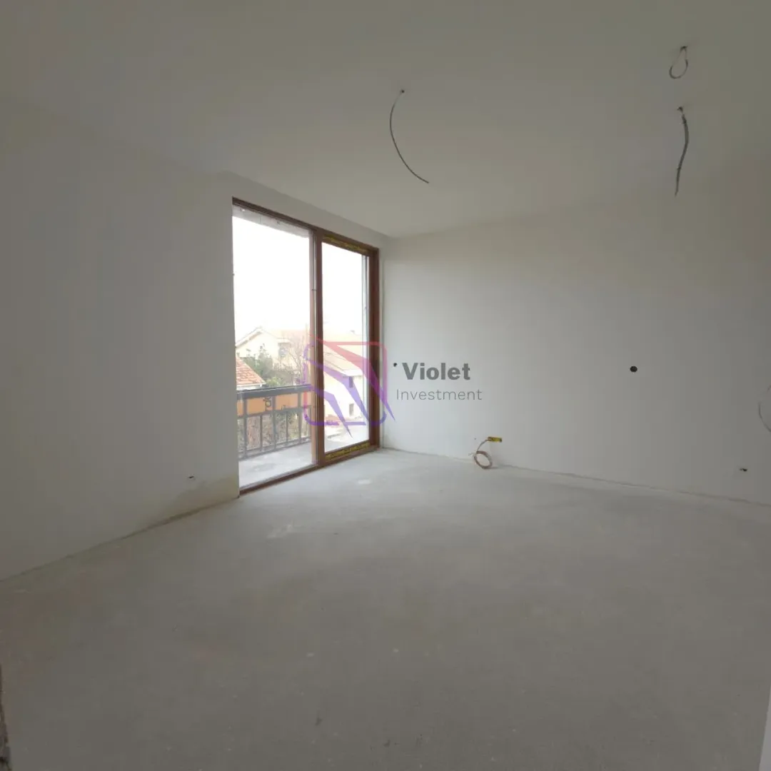 Empty unfurnished room under renovation with balcony doors.