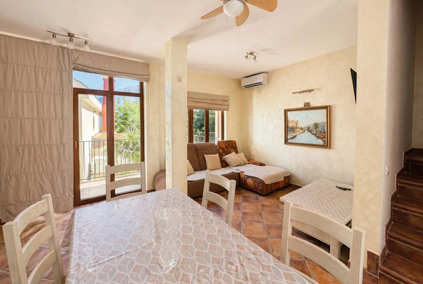 Living room with dining area and terrace access.