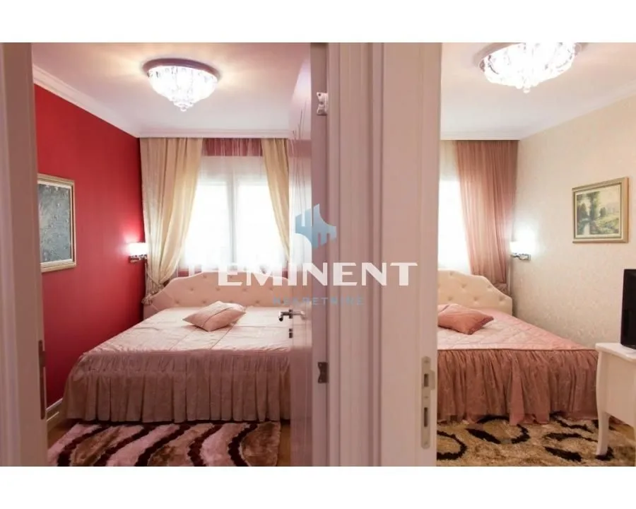 View from the hallway into a furnished bedroom with a double bed.