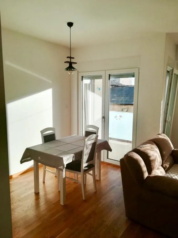 Living room with a dining table and a sofa.