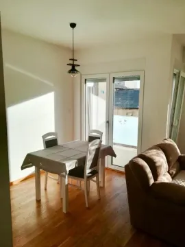 Living room with a dining table and a sofa. - image 4