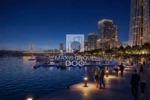 Night view of the illuminated marina and city promenade with buildings in the background. - image 9