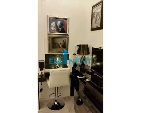 Living room with a desk and television. - image 5