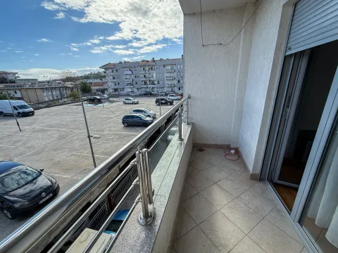 Spacious tiled balcony with metal railing and view of the parking area and neighborhood. - image 9
