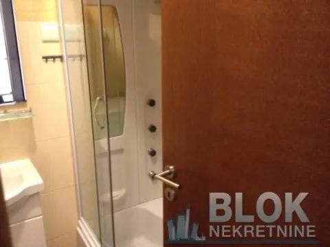 View of the bathroom with a shower cabin through the open door. - image 3