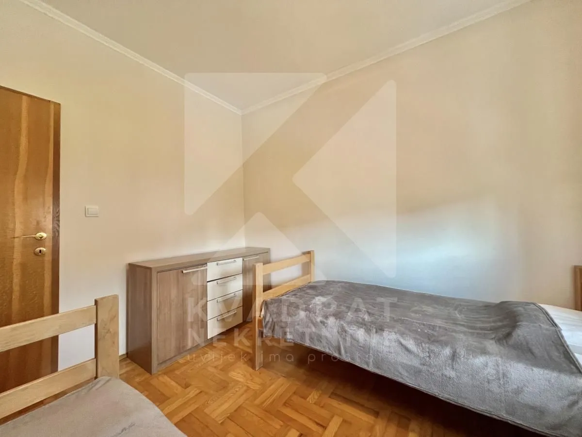 Bedroom with a bed and a wooden dresser.