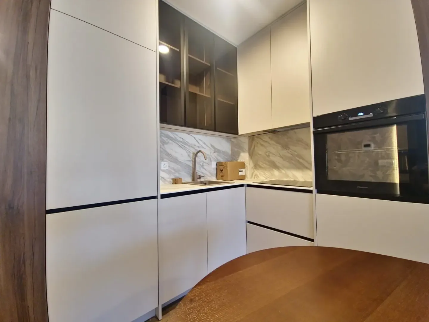 Modern kitchen with built-in units and white countertops.