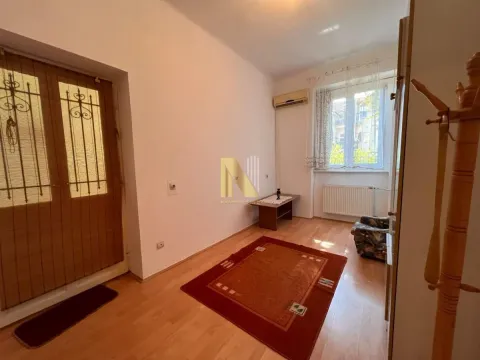 Living room with parquet flooring, a rug, and a window. - image 6