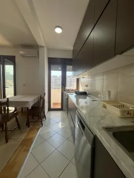 Smaller kitchen with a dining area and access to the terrace. - image 3