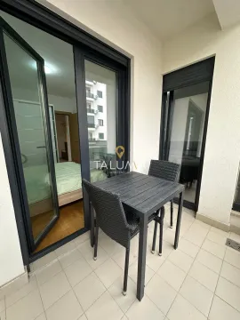 Furnished balcony with a table and chairs and a view into the interior. - image 7