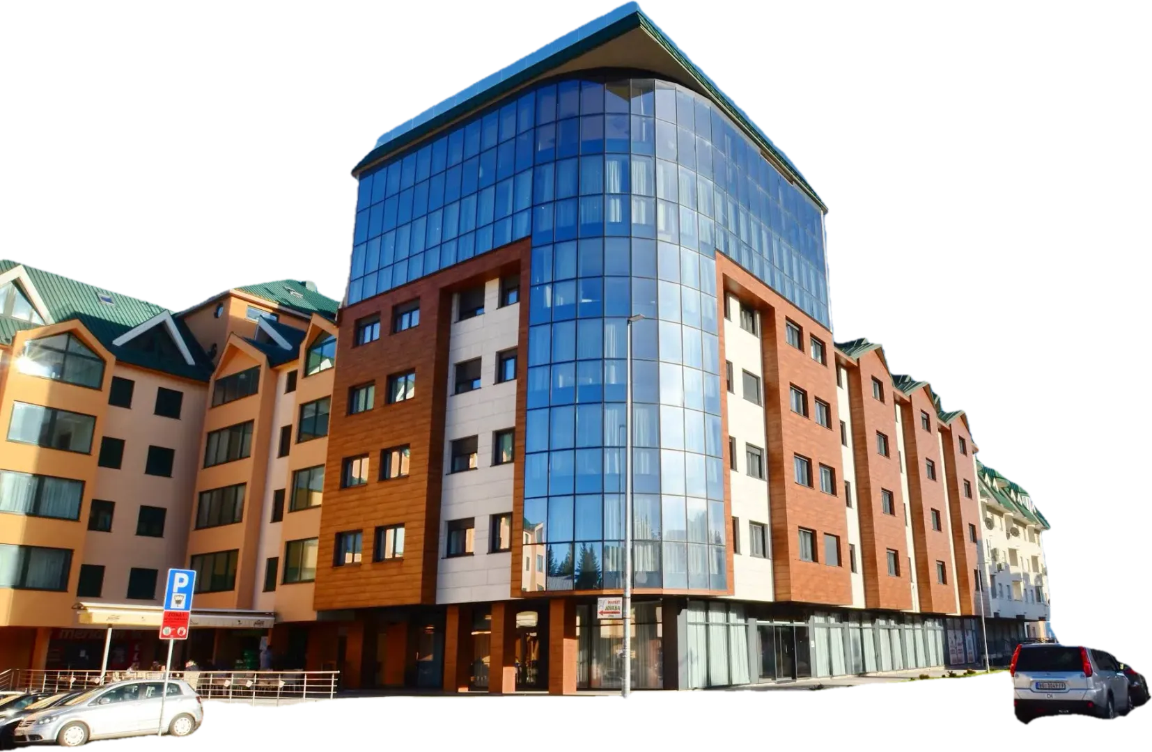 Spoljašnji izgled moderne stambeno-poslovne zgrade sa staklenom fasadom.