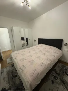 Bedroom with a double bed, wardrobe, and rugs. - image 5