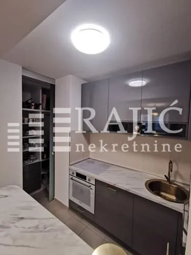 Modern kitchen with built-in appliances and sink.