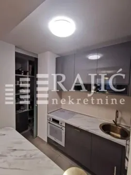 Modern kitchen with built-in appliances and sink. - image 12