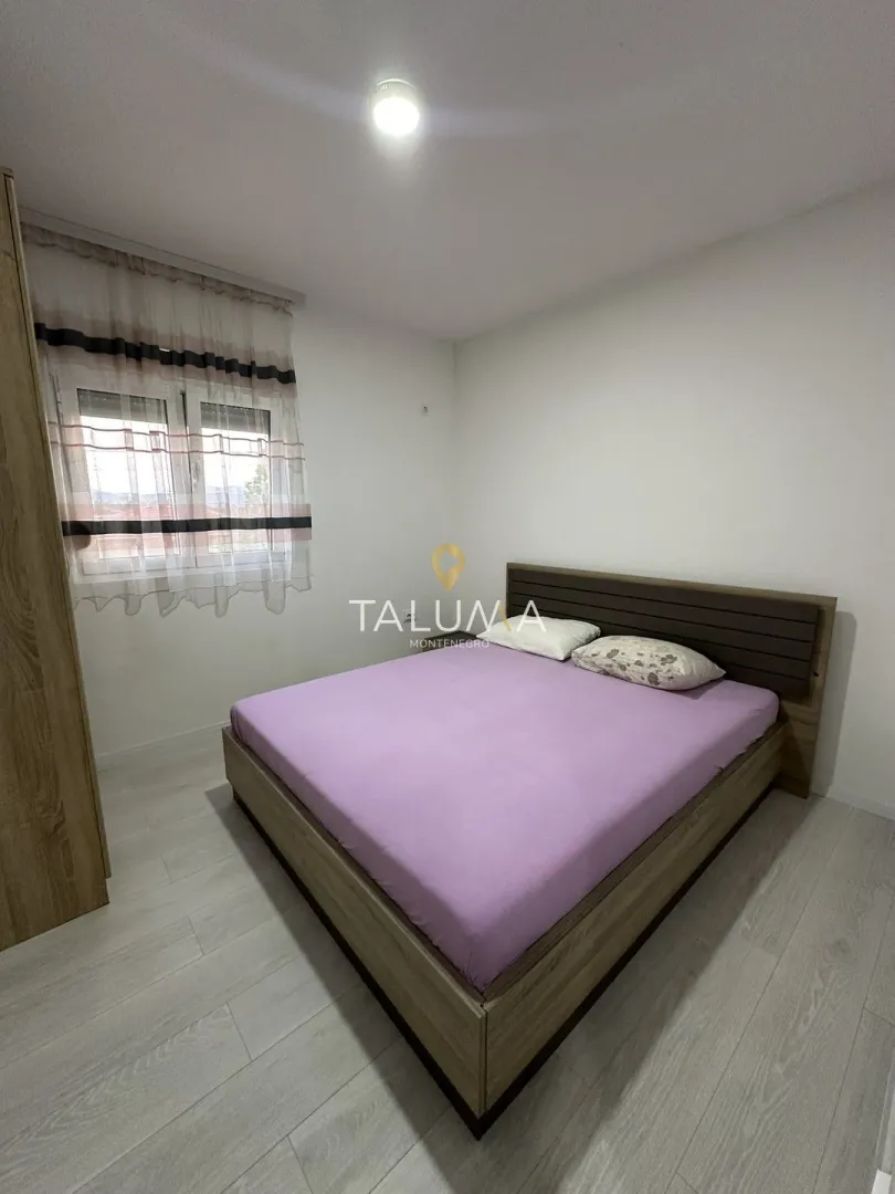 Bedroom with a double bed, wardrobe and a window.