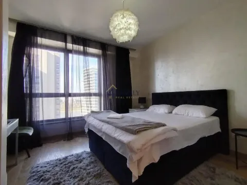 Bright bedroom with a double bed and a large window. - image 9