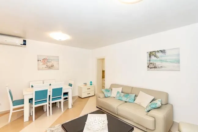 Living room with sofa and dining area.