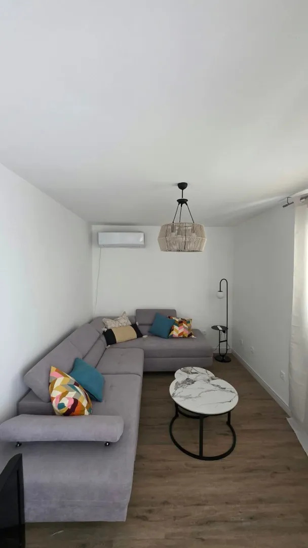 Bright living room with a corner sofa and a modern coffee table.