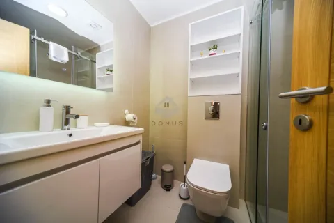Modern equipped bathroom with a washbasin, toilet, and shower cabin. - image 8