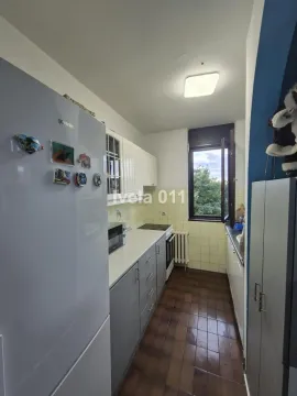 Small kitchen equipped with a refrigerator, stove, and upper and lower cabinets. - image 16