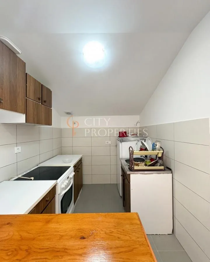 Smaller kitchen with wooden cabinets and built-in appliances.