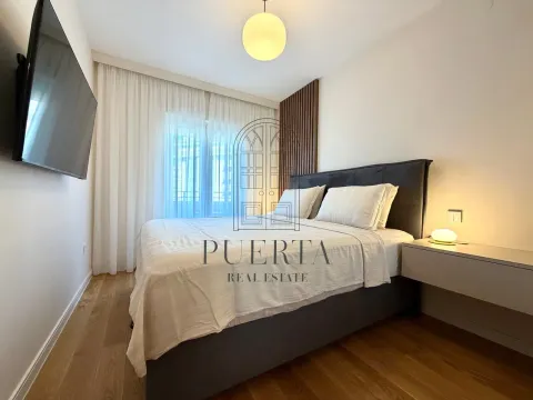 Modern bedroom with a double bed, wooden wall panel, and a television. - image 8