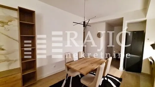 Dining area with a wooden table and chairs connected to the living room.