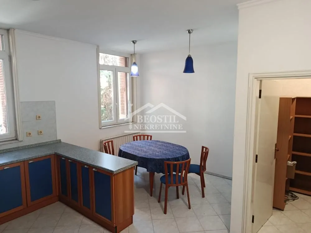 Kitchen with a dining area and blue kitchen units.