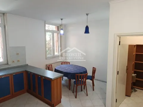 Kitchen with a dining area and blue kitchen units. - image 9