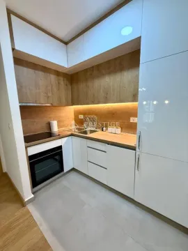 Modern kitchen with white cabinets and wooden details. - image 7