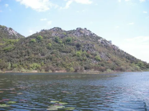 Pogled na jezero i zeleni brijeg u daljini. - image 7