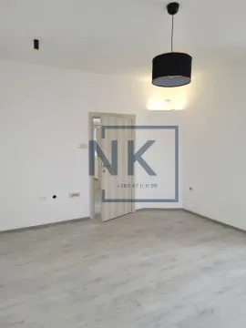 Empty bright room with laminate flooring and an open wooden door. - image 4