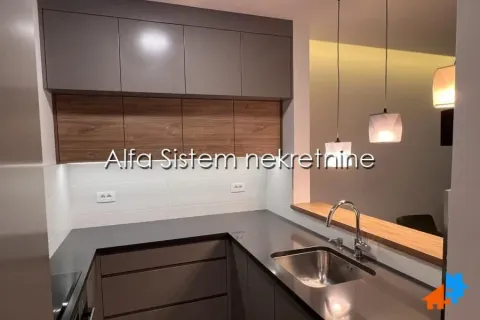 Modern kitchen with dark cabinets and wooden details. - image 3