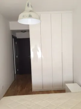 Bright bedroom featuring a large white built-in wardrobe. - image 7
