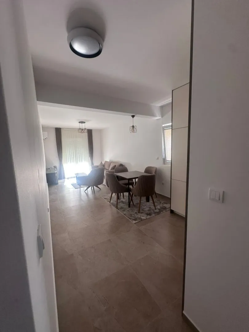 View from the hallway into the living room with a dining area.