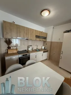 Smaller kitchen with a dining table and wooden elements. - image 7