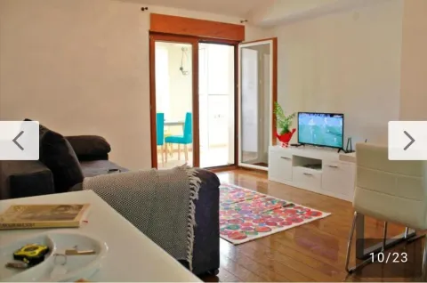 Living room with a sofa, TV, and access to the terrace. - image 3