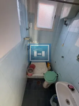 Smaller bathroom with tiles, toilet, and shower cabin. - image 7