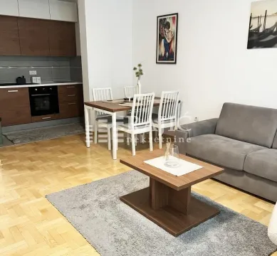 Living room with dining area and kitchen in an open space layout. - image 4