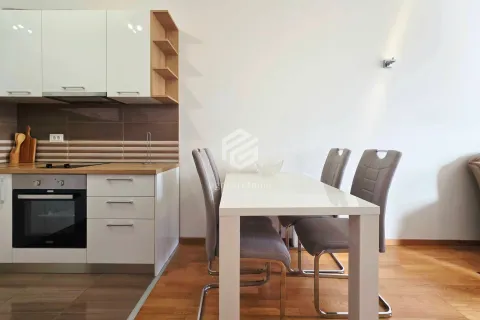 Kitchen with a dining area featuring white cabinets and a dining table with chairs. - image 4