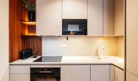 Modern kitchen with built-in appliances and a sink. - image 5