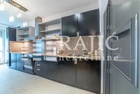 Modern kitchen with dark cabinets and a countertop. - image 9