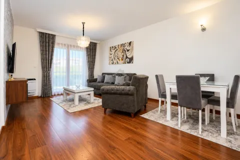 Living room with a sofa set and a dining area. - image 21