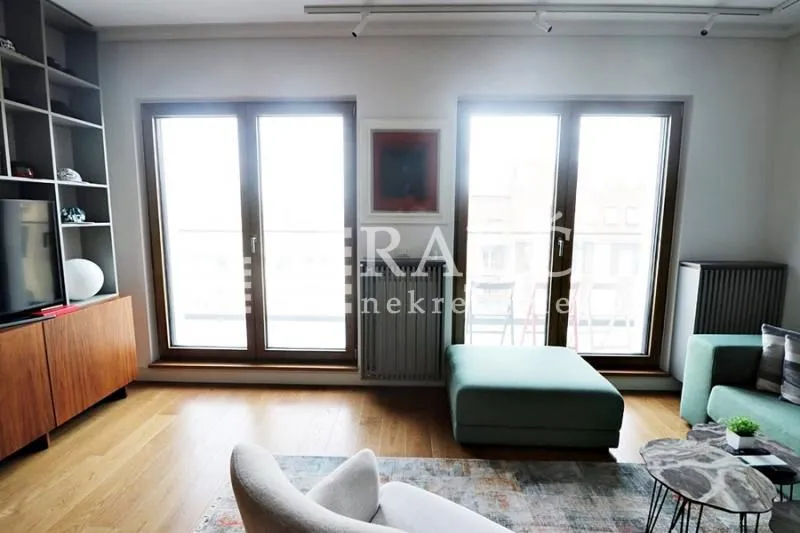Living room with furniture and large windows.