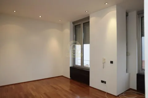 Empty room with hardwood floors and windows. - image 6