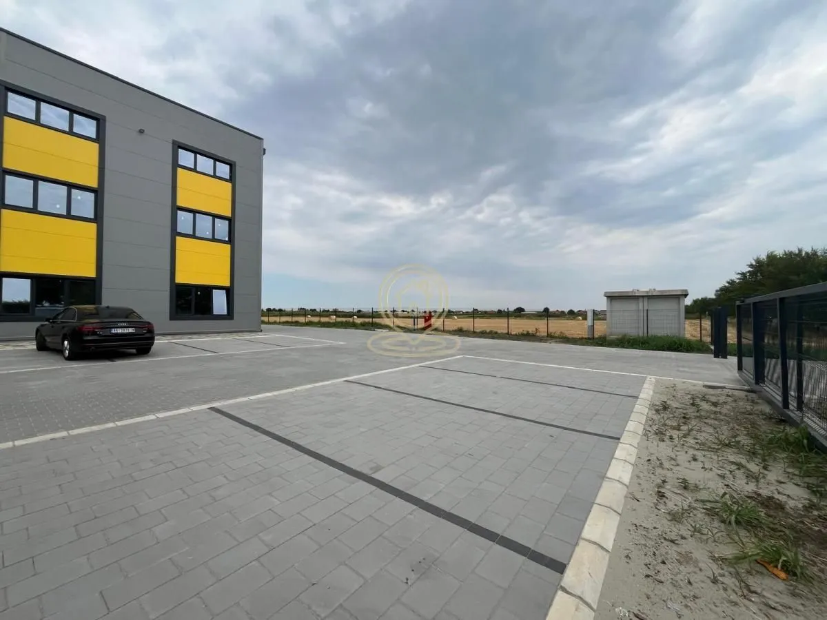 View of the paved parking lot in front of the commercial building.