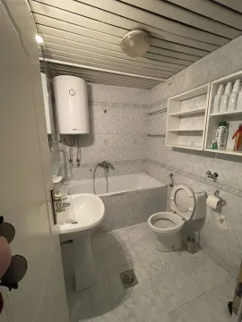Simple bathroom with a bathtub and boiler. - image 9