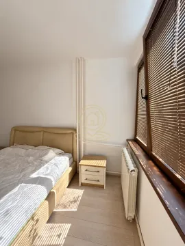 Bedroom with a bed, nightstand, and a window with blinds. - image 18